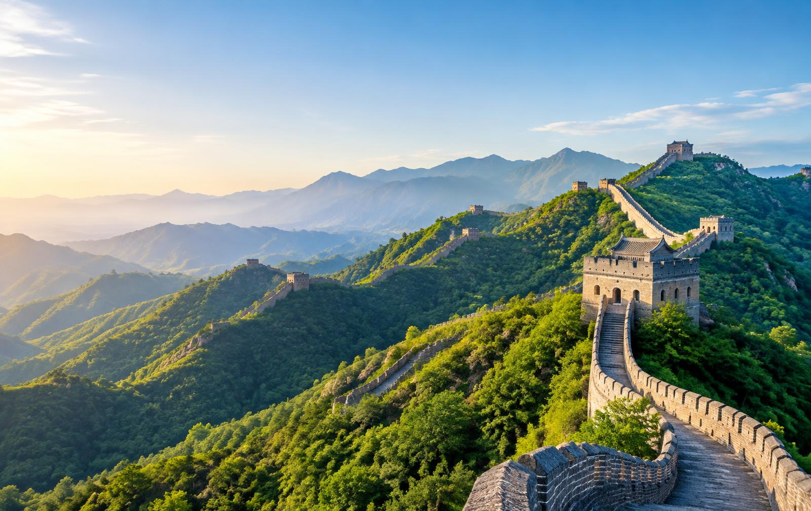 The Great Wall of China across green mountains