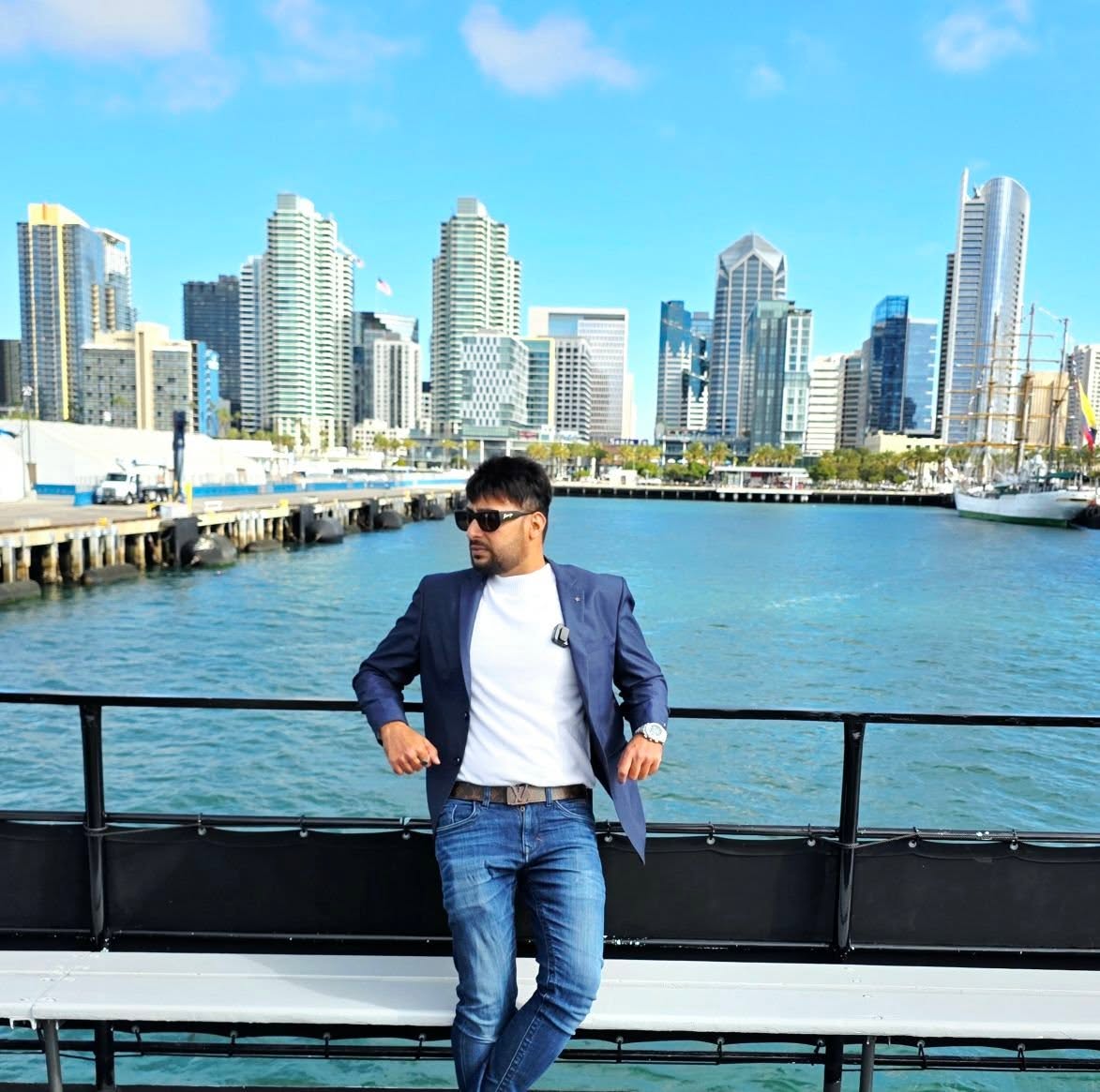 Shawez Shaikh overlooking a city skyline from the harbor